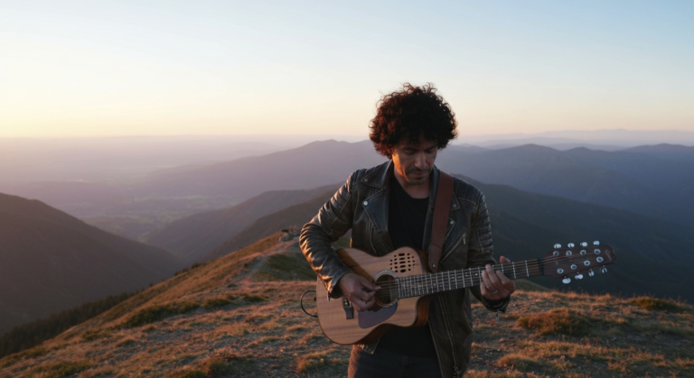 A musician playing a compact 7 string guitar on a scenic mountaintop, symbolizing musical freedom and travel.