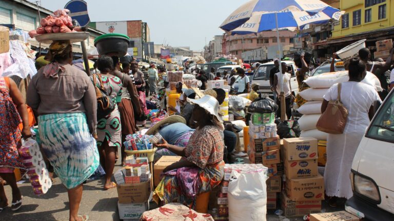 Busy street outside Makola Market in Accra, Ghana — traders, stalls and commerce