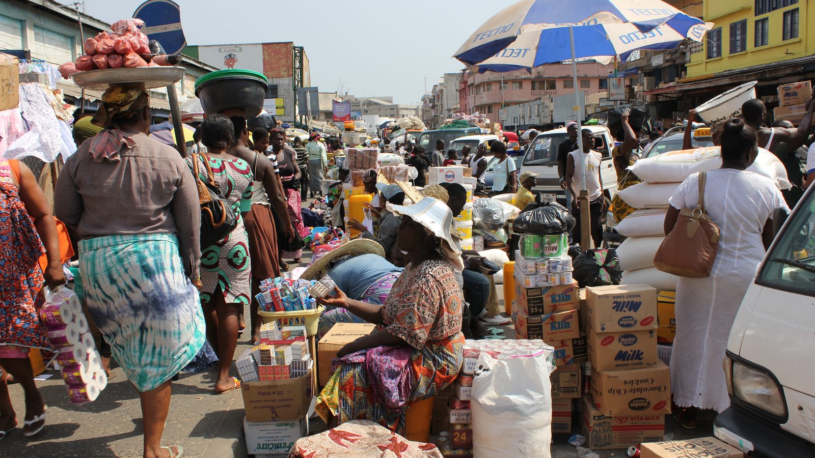 Busy street outside Makola Market in Accra, Ghana — traders, stalls and commerce