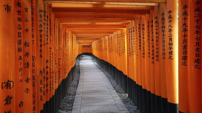 Vermilion torii gates lining the path at Fushimi Inari Taisha, Kyoto
