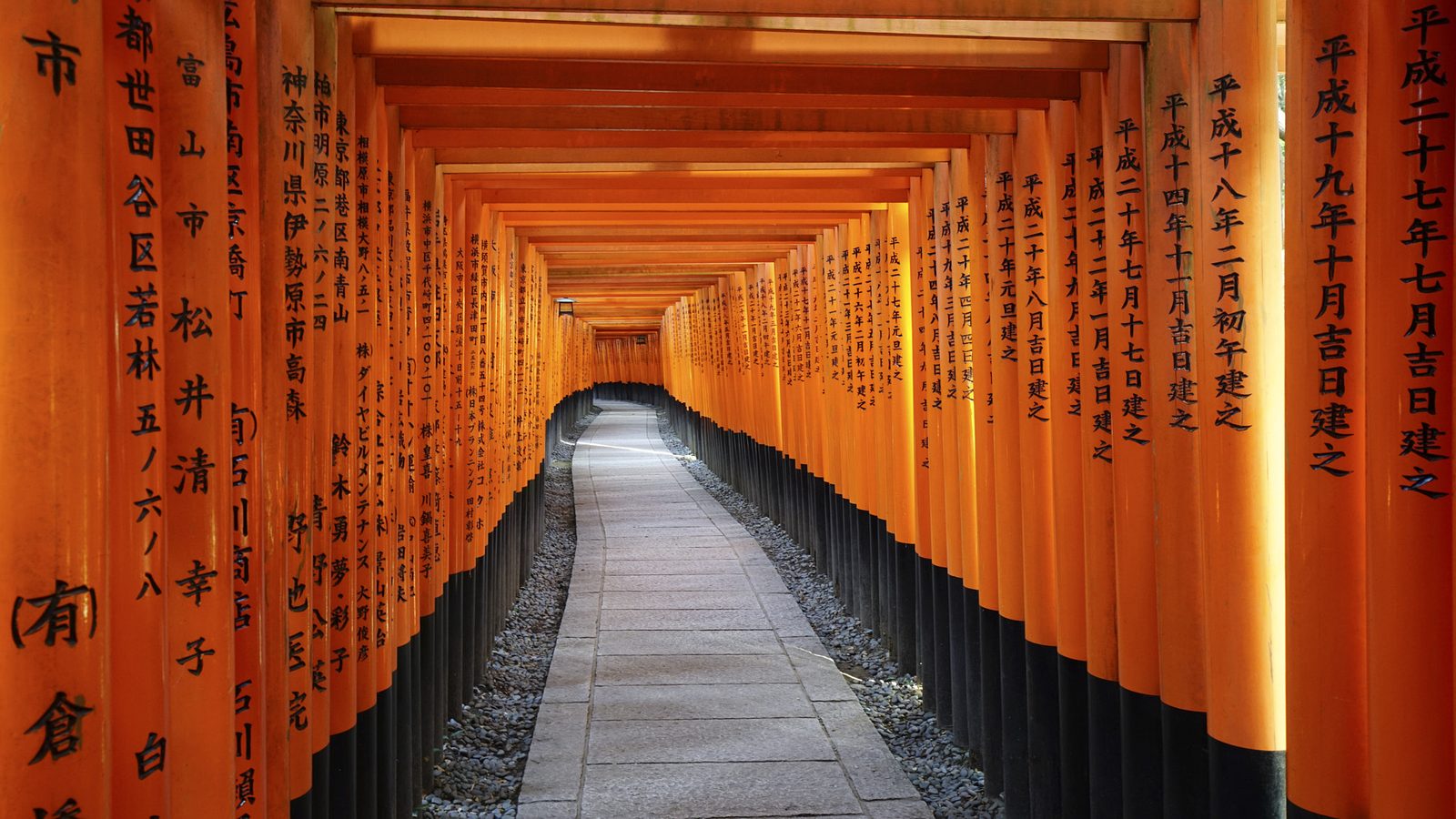Vermilion torii gates lining the path at Fushimi Inari Taisha, Kyoto