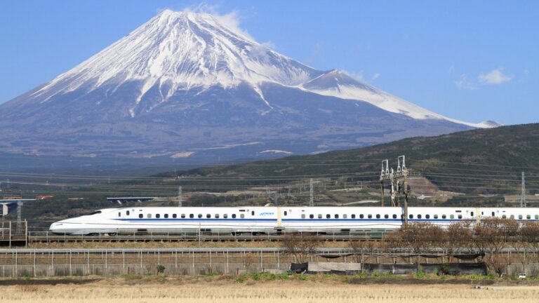 N700 Shinkansen bullet train passing below Mount Fuji, Japan
