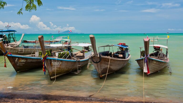 Longtail boats on turquoise water at Ao Nang, Krabi, Thailand