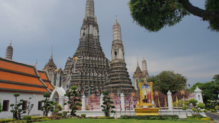 Wat Arun temple rising over the Chao Phraya river in Bangkok, Thailand